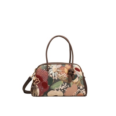 Mala Anekke com padrão floral multicolor em tons terra e alças castanhas