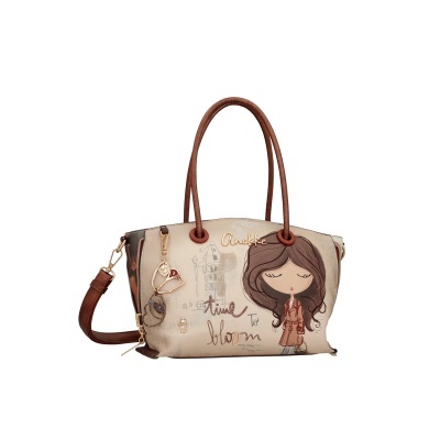 Mala de mão feminina bege e castanha com desenho e texto decorativo