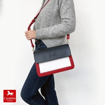 Mala de senhora em couro com relevo de cavalo e alça vermelha