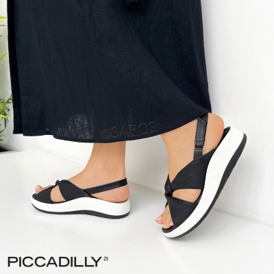 Sandálias femininas pretas com sola branca e tiras elásticas cruzadas