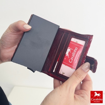 Carteira em pele castanha com fecho e cartão Cavalinho visível