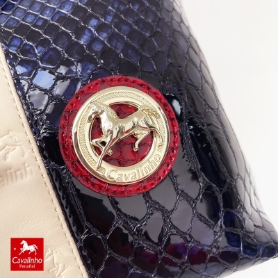 Bolsa Cavalinho em pele creme com padrão azul brilhante e emblema dourado