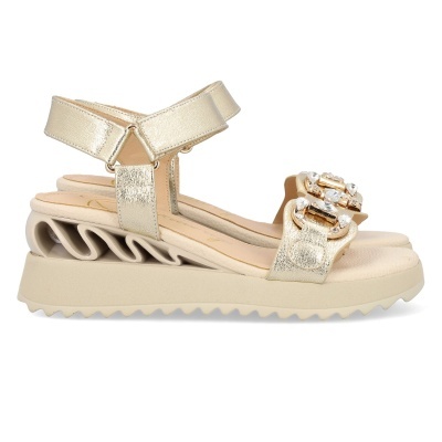 Sandália dourada com pedrarias e sola alta ondulada