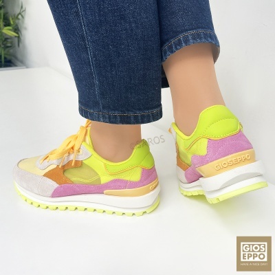 Ténis GIOSEPPO amarelo néon, lilás e bege com sola branca e detalhes em camurça, usados com calças de ganga.