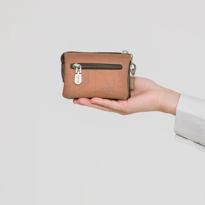Carteira bege pequena com fecho metálico Anekke na mão