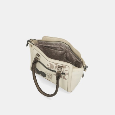 Mala de mão creme com padrão castanho e alças castanho escuro aberta com interior visível