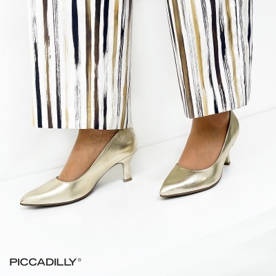 Sapatos de salto médio dourados em pele com calças riscas verticais