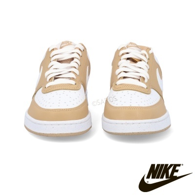 Ténis Nike bege e branco vistos de frente sobre fundo branco