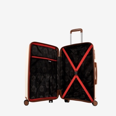 Mala de viagem rígida bege aberta com interior preto e detalhes vermelhos