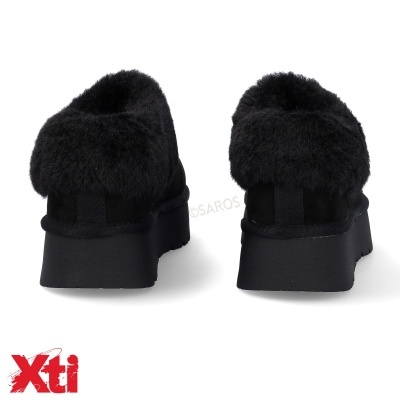 Sapatos pretos com pelo na parte traseira e sola grossa