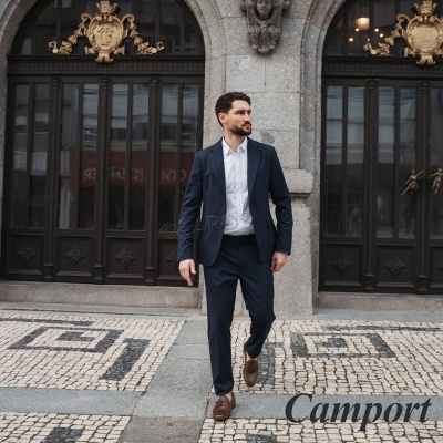Homem com fato azul-escuro e camisa branca numa calçada de mosaico português