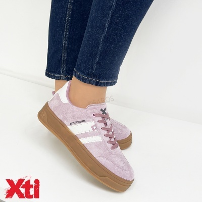 Ténis rosa Xti com sola castanha e atacadores rosa usados com jeans azul