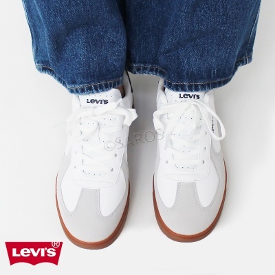 Par de sapatilhas brancas Levi's com sola castanha e detalhes cinzentos.