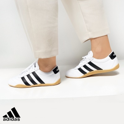 Ténis Adidas brancos com riscas pretas e sola castanha clara