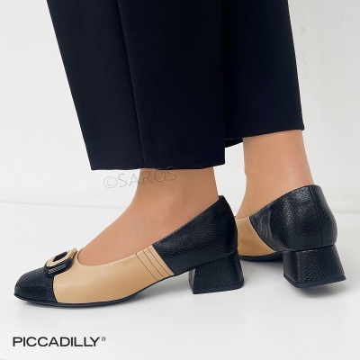 Sapatos femininos beges e pretos com salto médio e fivela dourada