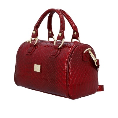 Mala de mão vermelha com padrão pele de cobra em fundo branco