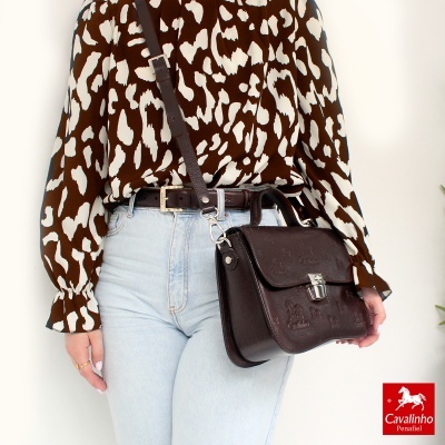 Mala tiracolo de couro castanho com relevos de cavalos e fecho prateado