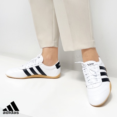 Ténis Adidas brancos com riscas pretas e sola castanha