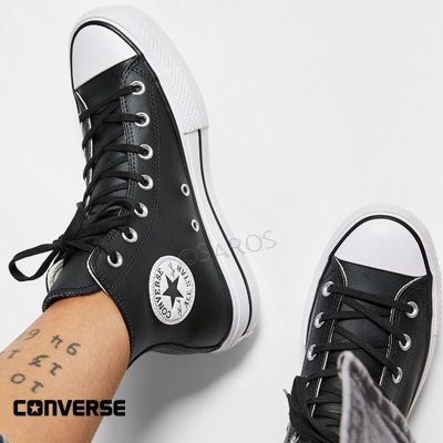 Ténis Converse All Star preto de cano alto em pele com sola branca e logótipo lateral.