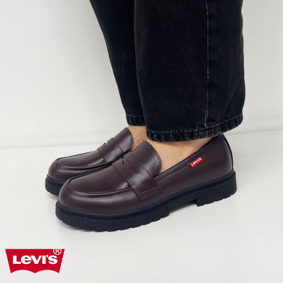 Sapatos mocassim castanhos escuros com sola preta e etiqueta Levis vermelha