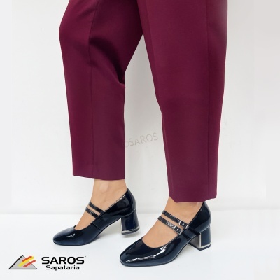 Sapatos pretos de salto médio brilhante com duas tiras e fivelas usados com calças vinho