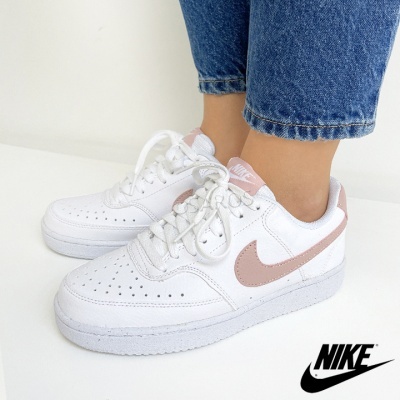 Ténis Nike brancos com detalhe rosa e sola branca, calçados, fundo branco.