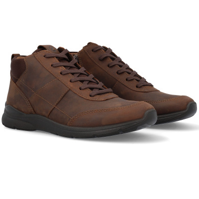 par de sapatos desportivos em couro castanho com sola preta