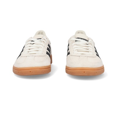 Par de sapatilhas desportivas brancas com riscas negras e sola castanha