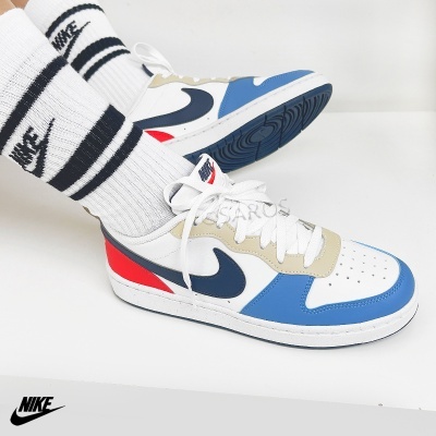 Ténis Nike multicoloridos com meias brancas e pretas em fundo branco