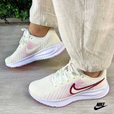 Ténis Nike brancos com detalhes rosa e marga vinho em malha respirável