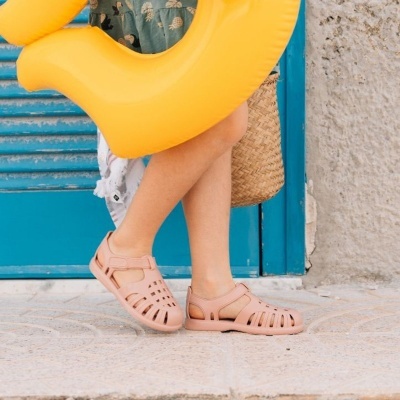Sandálias cor de rosa em pele sintética para criança com fecho de velcro.