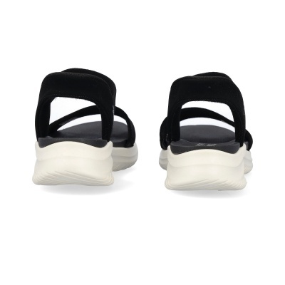 Sandálias pretas com sola branca vista de trás