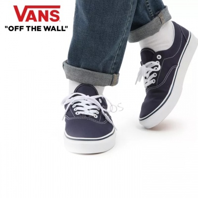 Ténis Vans azuis escuros com atacadores e sola brancos em fundo branco