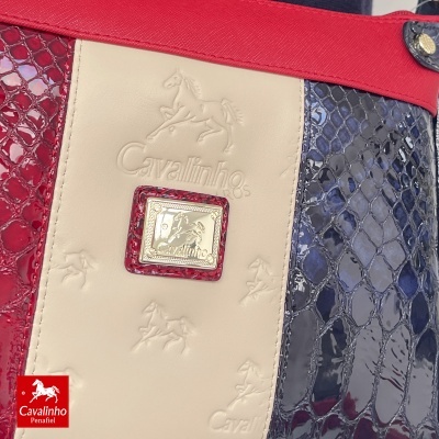 Mala de senhora Cavalinho com padrões de pele imitação cobra em vermelho, creme e azul escuro