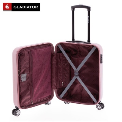 Mala de viagem rígida rosa clara aberta com interior bordô, quatro rodas e cabo telescópico