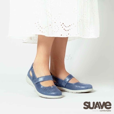 Sapatos azuis femininos em pele com sola branca, usados com vestido branco bordado.
