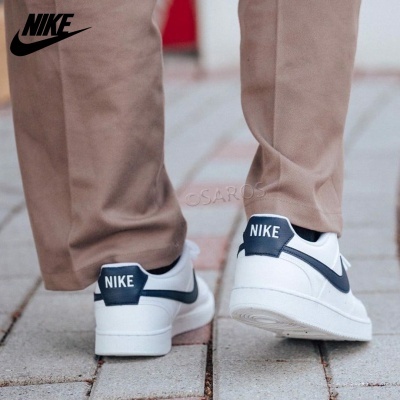 Sapatilhas Nike brancas com detalhes azuis e logo NIKE no calcanhar