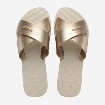 Chinelos Havaianas dourados com tiras cruzadas e sola bege texturada