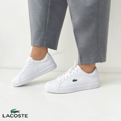 Ténis brancos Lacoste com logo de crocodilo verde bordado.