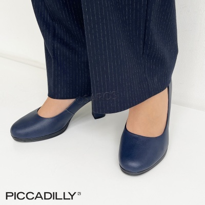 Sapatos de salto médio em couro azul escuro usados com calças azul escuro com riscas finas