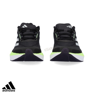 Tênis desportivos Adidas pretos com detalhes em verde limão e sola branca e preta vistos de frente