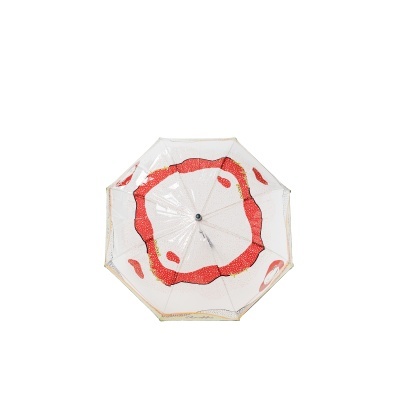 Guarda-chuva transparente com padrão vermelho que imita fatia de tomate.