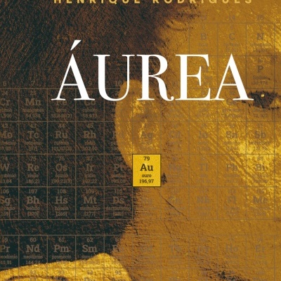Capa de livro com título ÁUREA e autor HENRIQUE RODRIGUES em fundo preto e dourado com tabela periódica destacando ouro Au.