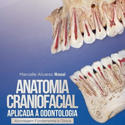 Capa de livro azul com dentes cortados ao meio mostrando anatomia craniofacial para odontologia