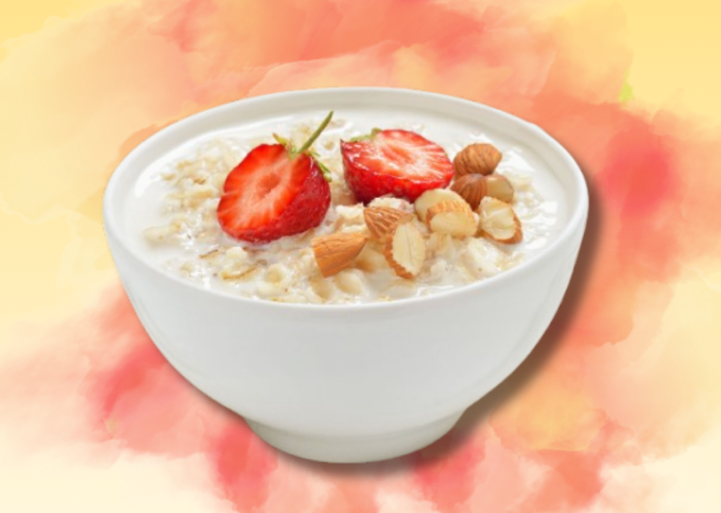 Tigela branca com papas de aveia, morangos e amêndoas