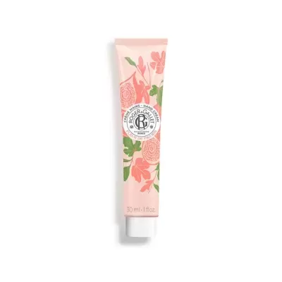 Tubo de creme rosa com flores e tampa branca