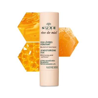 Bálsamo labial NUXE RÊVE DE MIEL com mel e favo de mel ao fundo