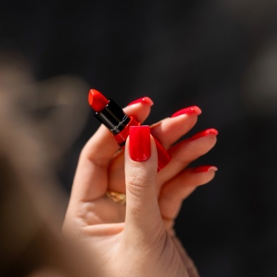 Batom vermelho MAC e mão com unhas vermelhas