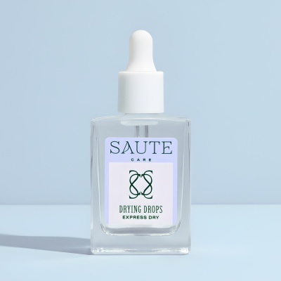 Frasco de vidro com conta-gotas branco e etiqueta SAUTE CARE DRYING DROPS EXPRESS DRY