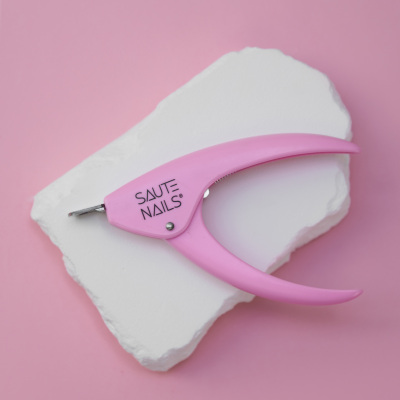 Alicate para unhas cor-de-rosa SAUTE NAILS em fundo rosa e base branca
